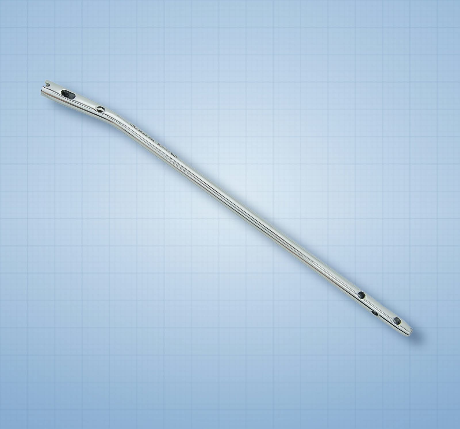 Interlocking Nail — Tibia: orthopaedic implant on a light-blue graph-paper background